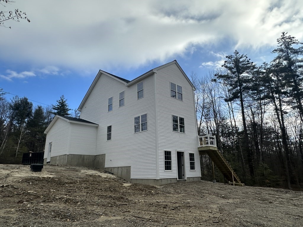 38 Juniper Road Ashburnham, MA 01430 - Photo 7 of 19 a view of a white house with a yard