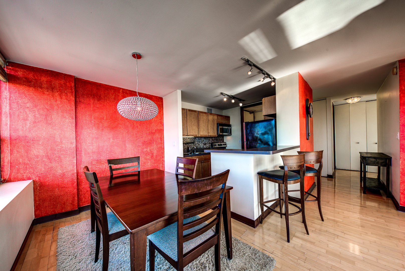 655 West Irving Park Road, Unit 3817 Chicago, IL 60613 - Photo 11 of 28 a view of a dining room with furniture and wooden floor