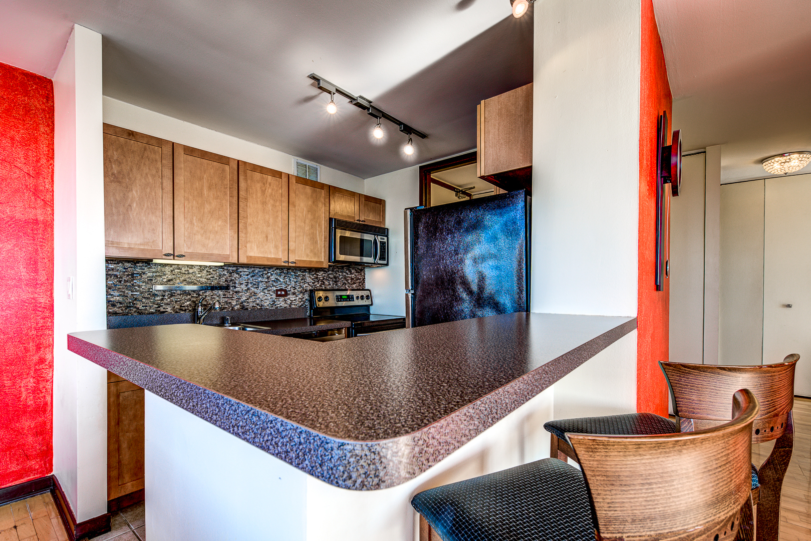 655 West Irving Park Road, Unit 3817 Chicago, IL 60613 - Photo 12 of 28 a view of a kitchen with kitchen island a large counter top space a sink stainless steel appliances and cabinets