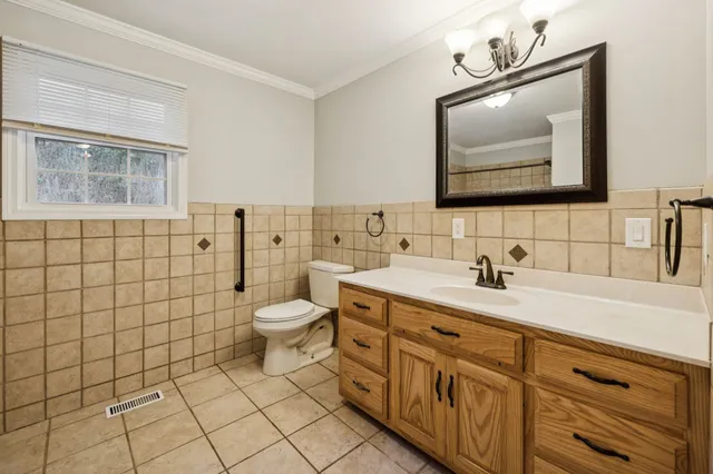 a bathroom with a toilet sink a mirror and shower