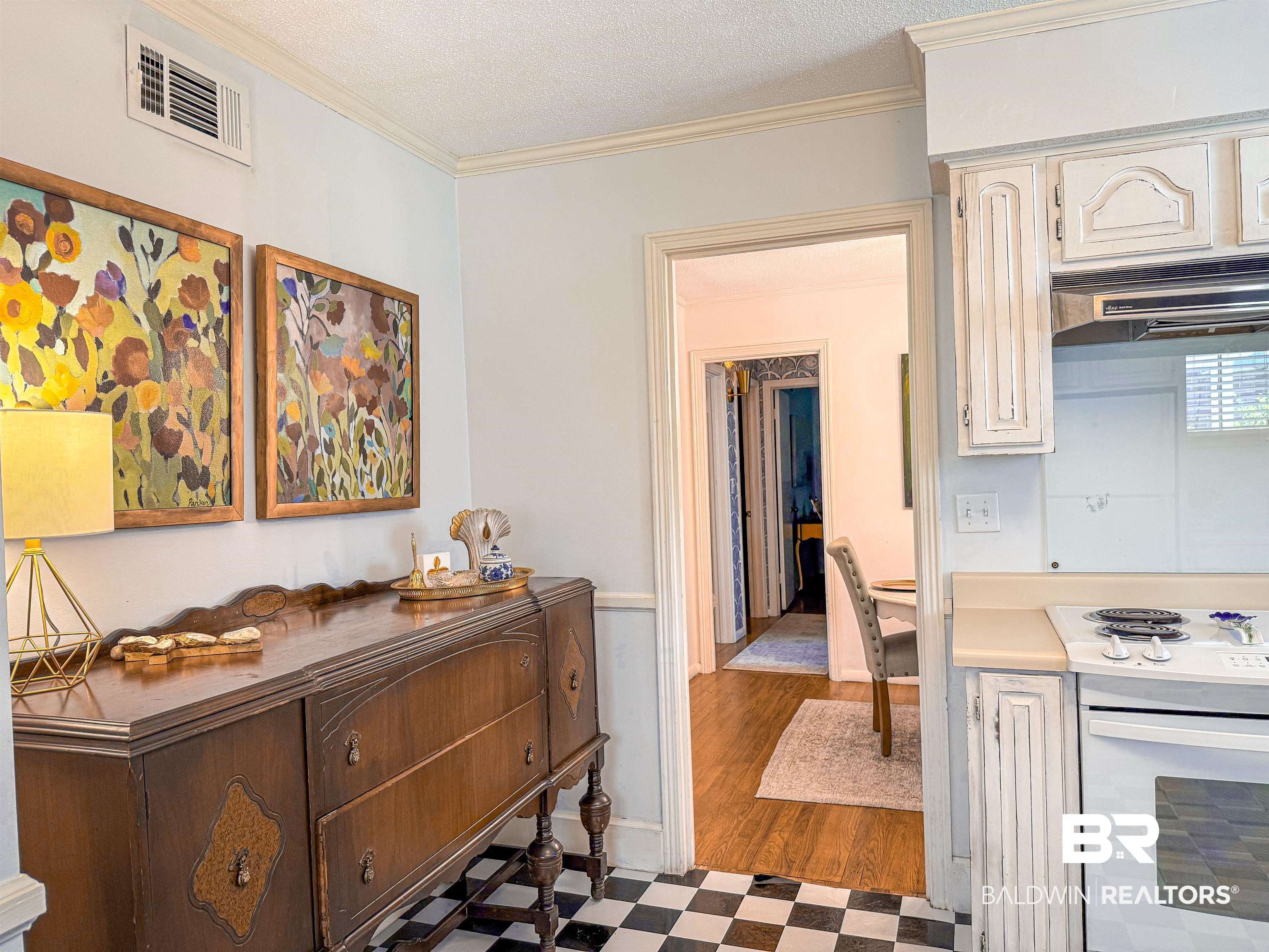 1508 Poplar Avenue Brewton, AL 36426 - Photo 9 of 22 Kitchen featuring white electric range, crown molding, light countertops, under cabinet range hood, and a textured ceiling