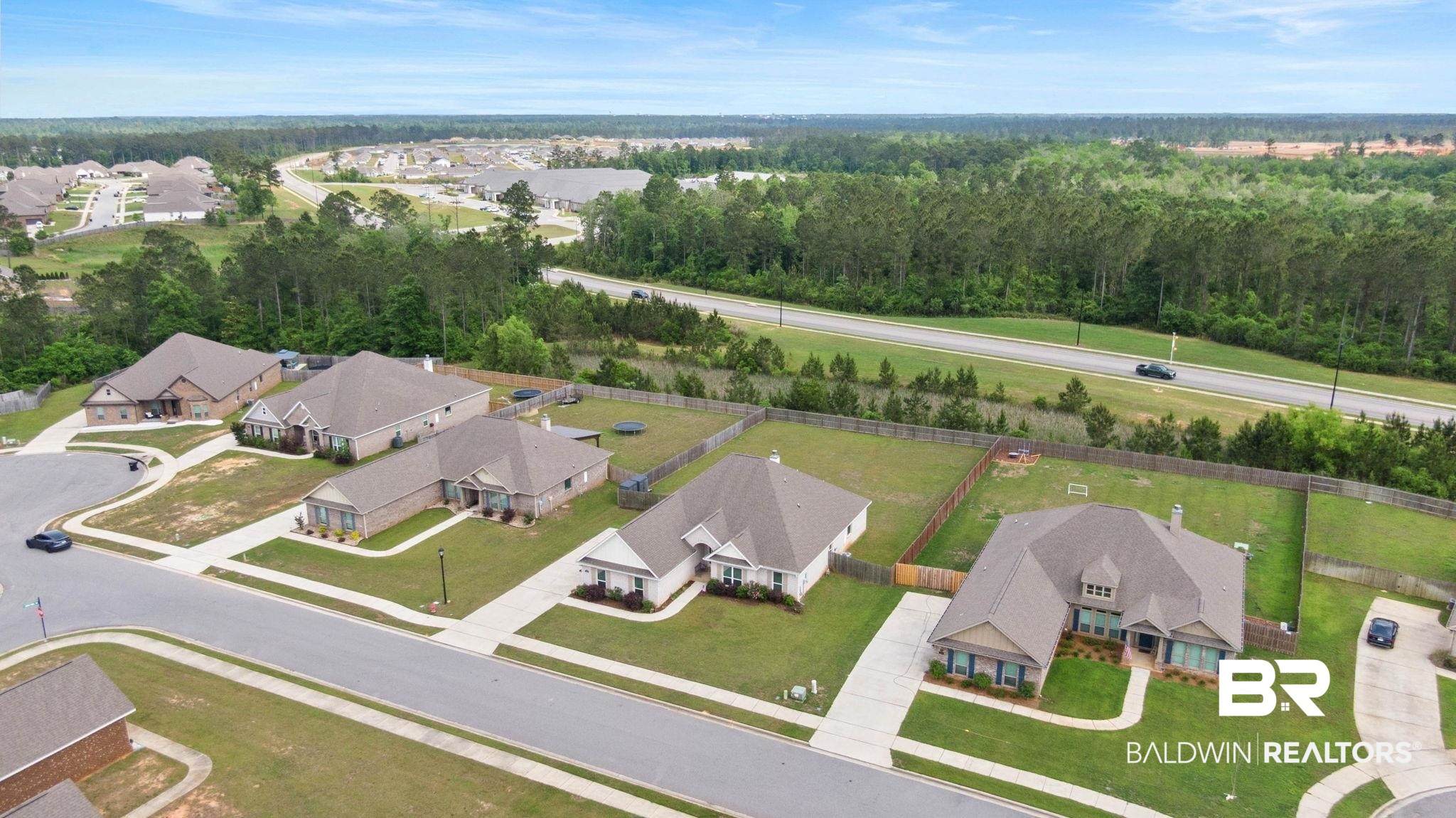 31187 Spoonbill Road Daphne, AL 36527 - Photo 67 of 85 Residential neighborhood featuring single-story homes with brick and siding exteriors, concrete driveways, and manicured lawns