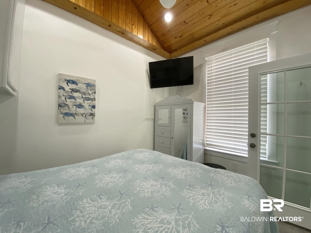 28888 Canal Road, Unit 77 Orange Beach, AL 36561 - Photo 11 of 23 Vaulted wood-plank ceiling featuring a built-in light fixture
