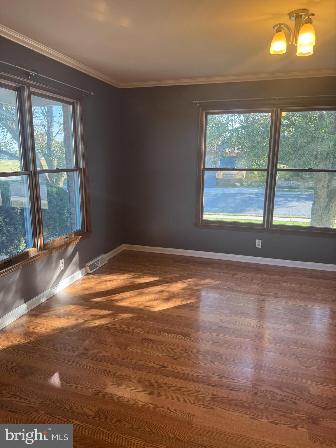 3312 Scotland Road Chambersburg, PA 17202 - Photo 7 of 32 a view of an empty room with wooden floor and a window