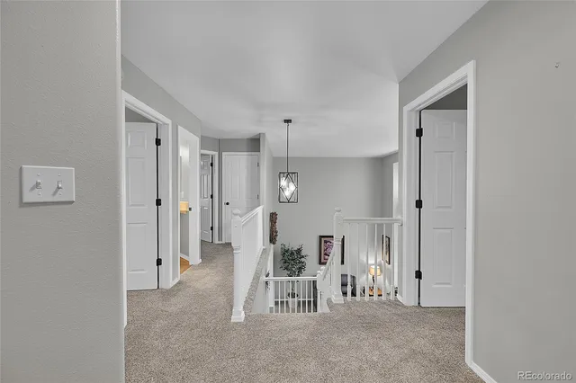 a spacious bedroom with a bed and a ceiling fan