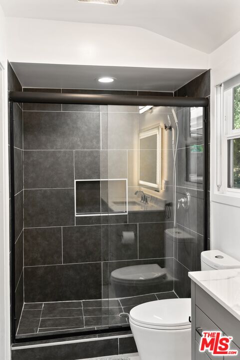 4118 Oak Hollow Road Calabasas, CA 91302 - Photo 45 of 55 a bathroom with a toilet a sink and shower