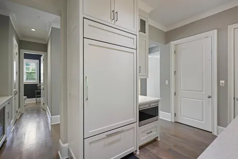 a bathroom with a granite countertop sink toilet and mirror