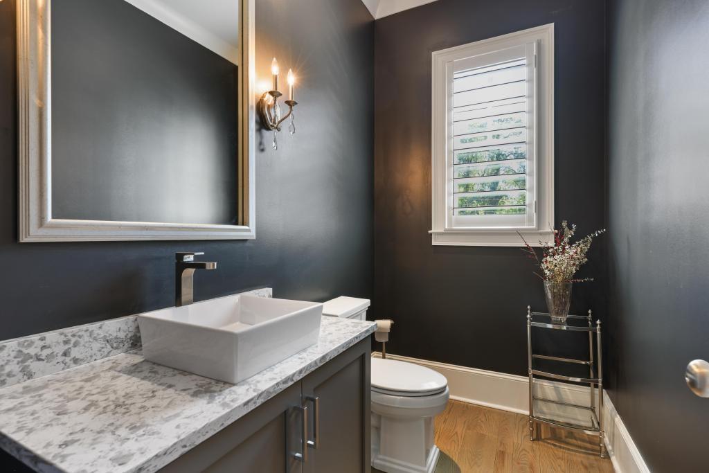 5980 Teton Way Atlanta, GA 30328 - Photo 16 of 48 a bathroom with a granite countertop sink toilet and mirror