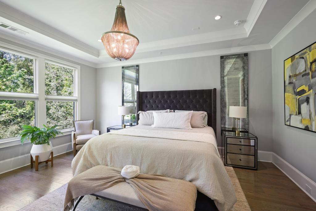5980 Teton Way Atlanta, GA 30328 - Photo 18 of 48 a bedroom with a bed and a chandelier