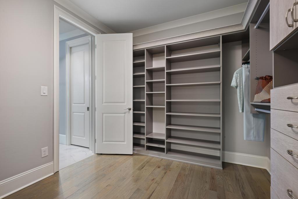 5980 Teton Way Atlanta, GA 30328 - Photo 22 of 48 a view of walk in closet with empty racks
