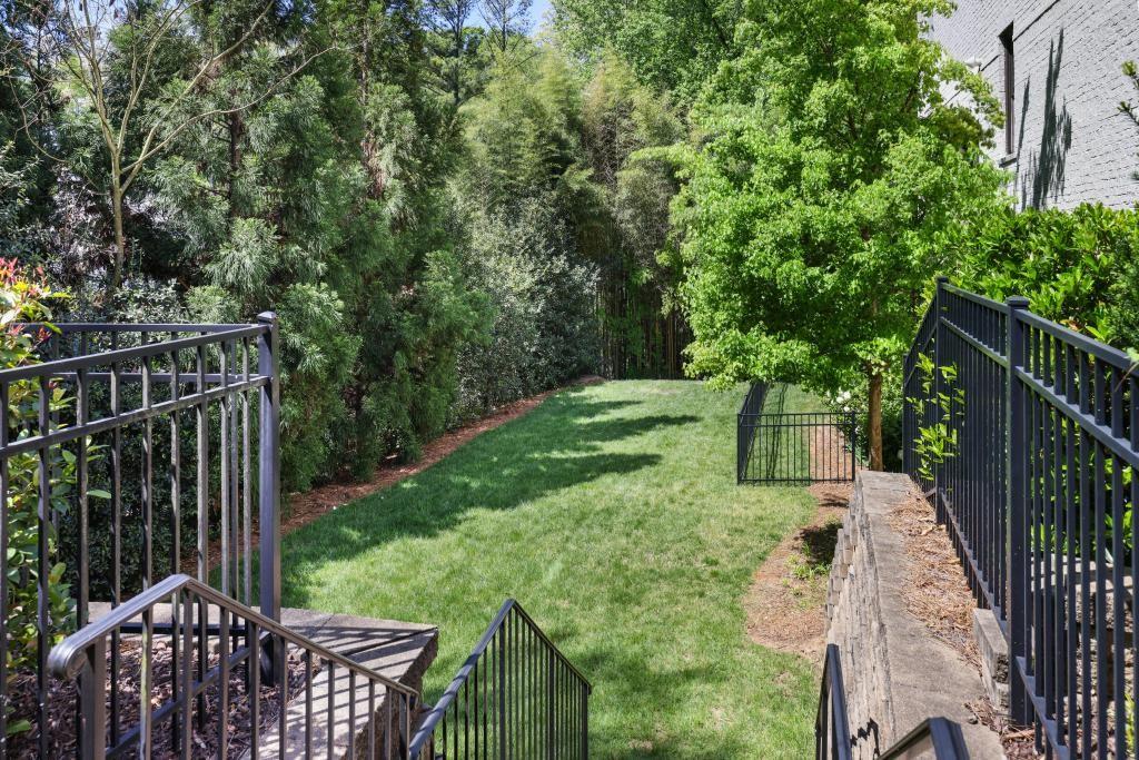 5980 Teton Way Atlanta, GA 30328 - Photo 37 of 48 a view of backyard with wooden fence and trees