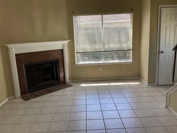 a view of an empty room with a fireplace