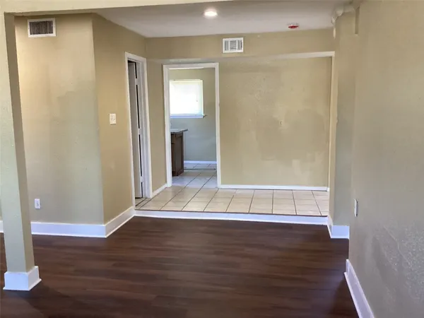 a view of wooden floor with entryway