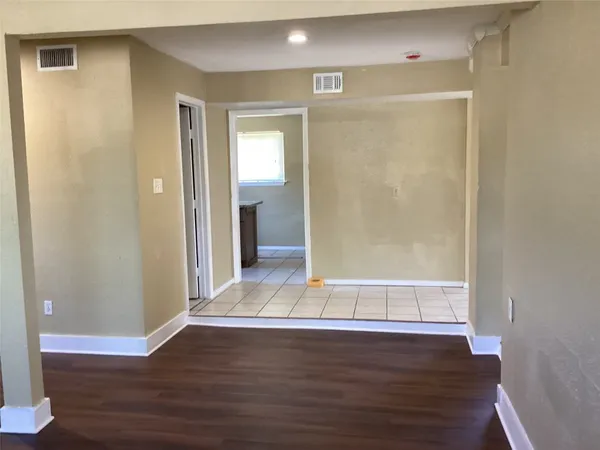 a view of wooden floor and windows in a room