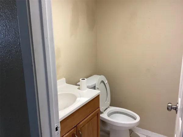a white toilet sitting next to a bathroom sink