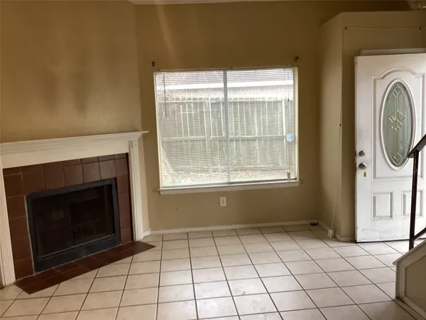 a view of a livingroom with a fireplace and window