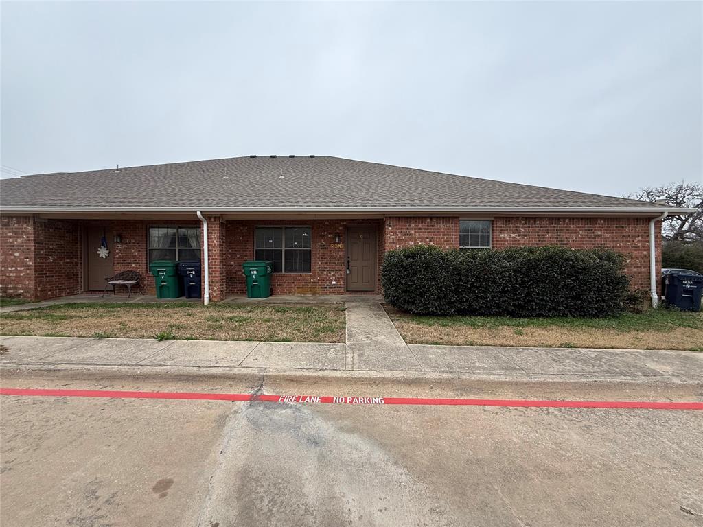 2331 North Elm Street, Unit 2 Denton, TX 76201 - Photo 1 of 1 Single story home with a shingled roof and brick siding