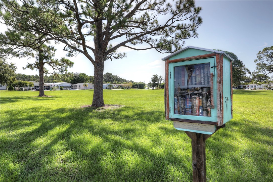 1352 Barefoot Circle Sebastian, FL 32976 - Photo 28 of 29 a yellow house with trees in front of it