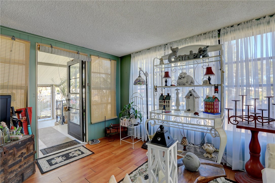 1352 Barefoot Circle Sebastian, FL 32976 - Photo 6 of 29 a room with furniture gym equipment and a large window