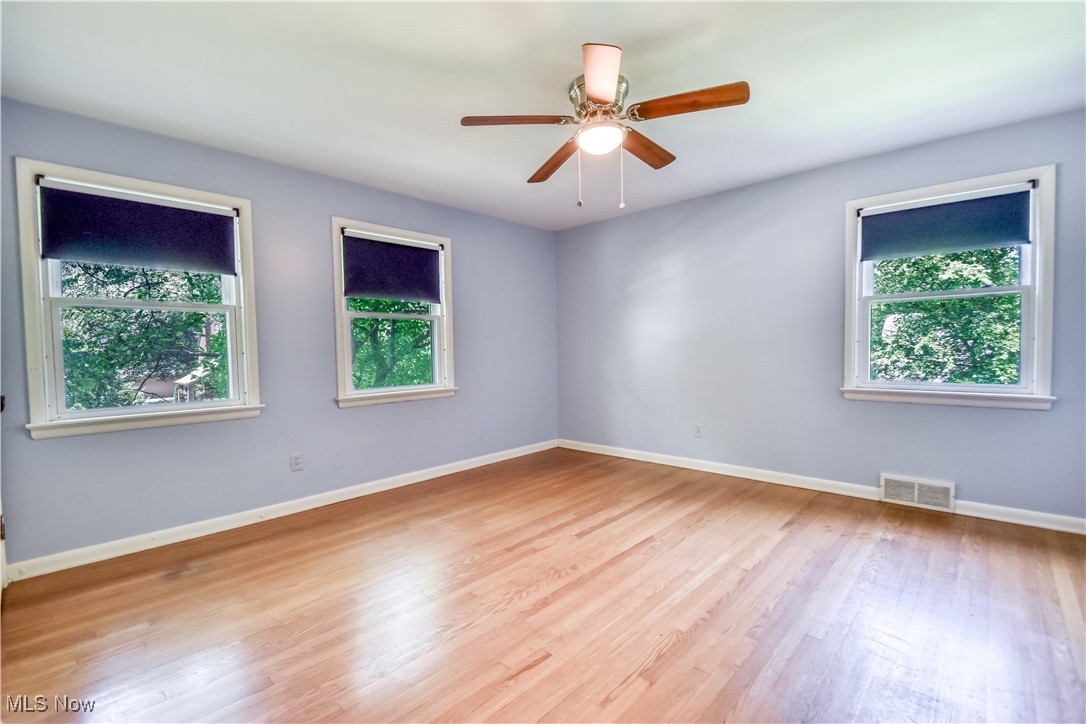 2607 Ashurst Road University Heights, OH 44118 - Photo 32 of 39 Unfurnished room with healthy amount of natural light, wood finished floors, and a ceiling fan