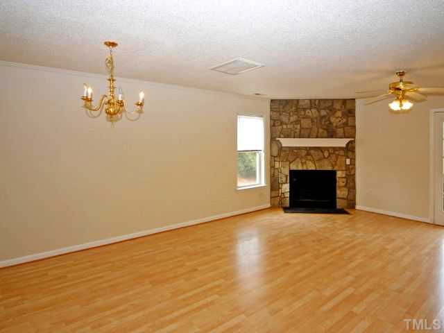 5952 Shady Grove Circle Raleigh, NC 27609 - Photo 11 of 25 a view of a livingroom with a fireplace and a chandelier