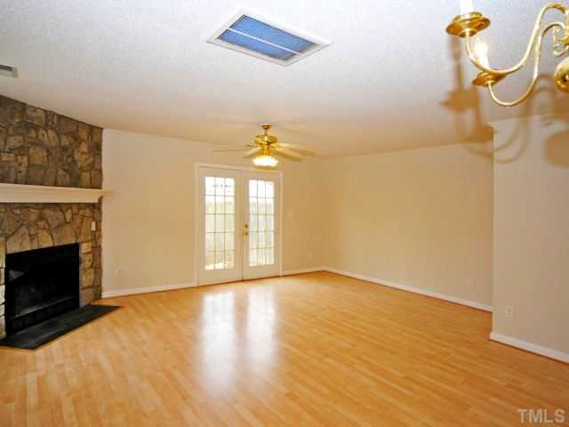 5952 Shady Grove Circle Raleigh, NC 27609 - Photo 14 of 25 a view of an empty room with a window and wooden floor