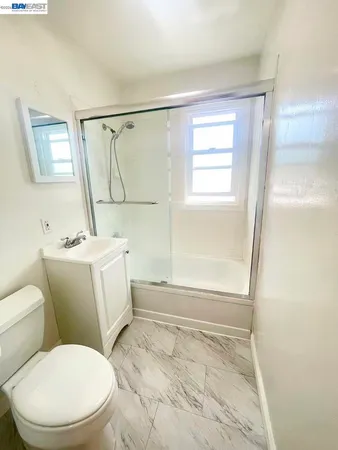 a white toilet sitting next to a bathroom sink