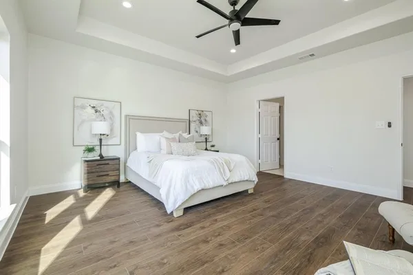 a bedroom with a bed and a chandelier