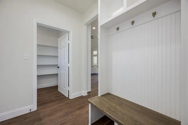 a view of an empty room with wooden floor