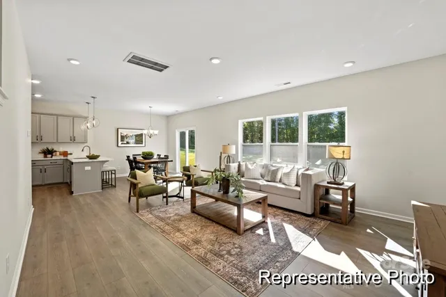 a living room with furniture wooden floor and a table
