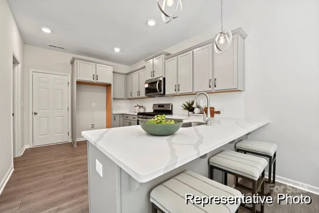 a kitchen with refrigerator and cabinets