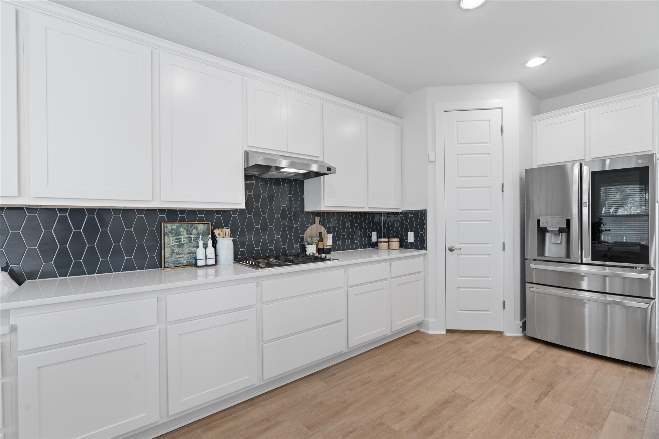 109 Wake Lane Georgetown, TX 78633 - Photo 13 of 34 a kitchen with appliances a sink and cabinets