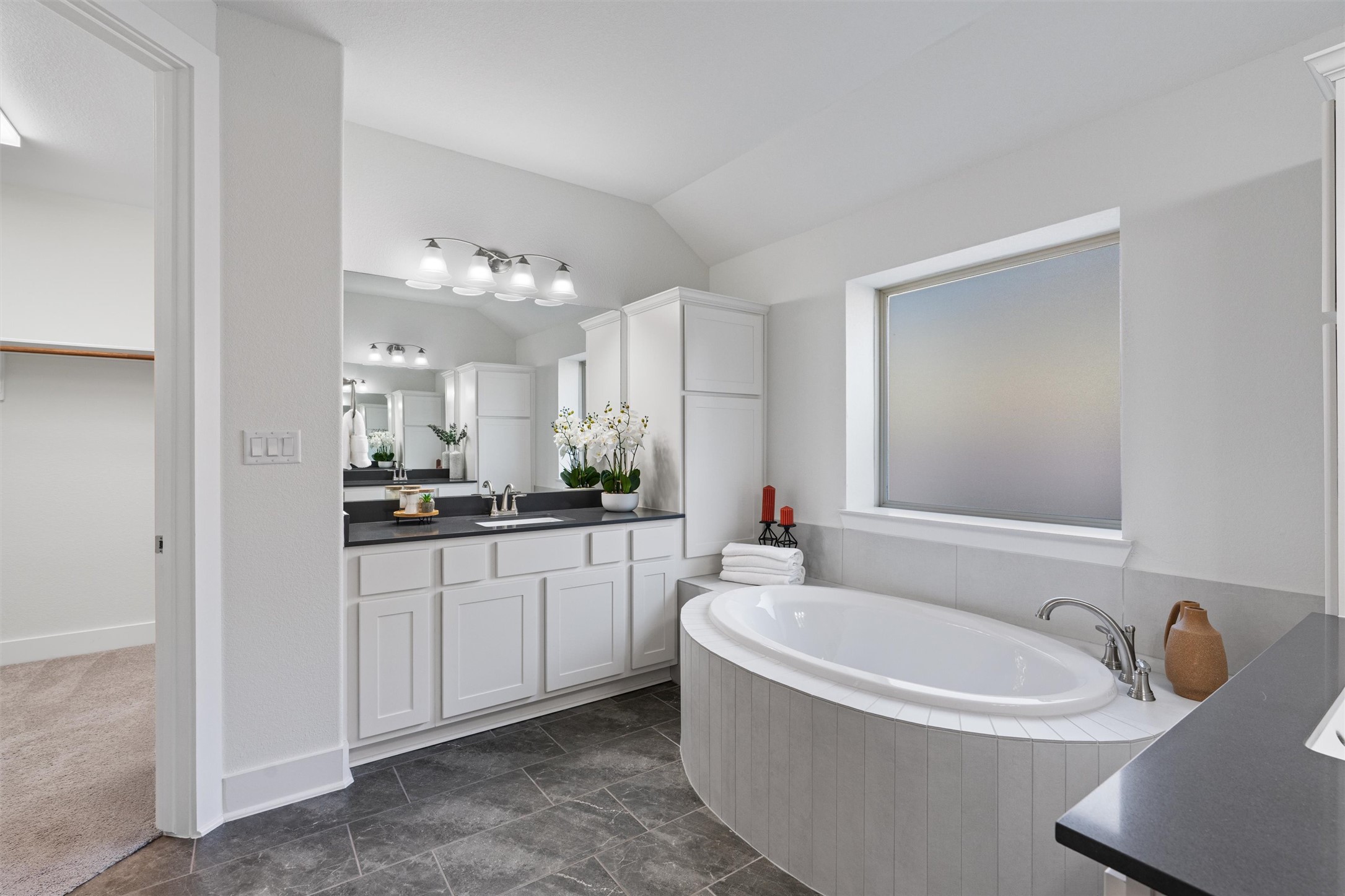 109 Wake Lane Georgetown, TX 78633 - Photo 9 of 34 a bathroom with a bathtub a double vanity sink and mirror
