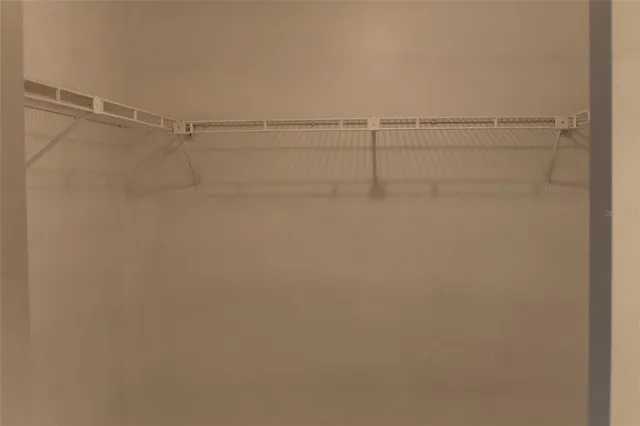 a bathroom with a granite countertop toilet and a sink