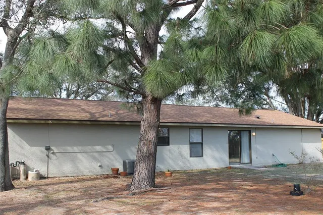 a house that has a tree in front of it