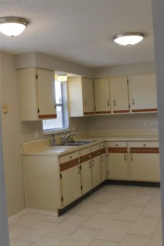 a kitchen with sink and cabinets