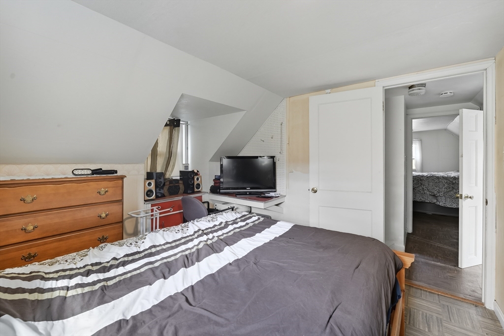 145 Amostown Road West Springfield, MA 01089 - Photo 17 of 26 a bedroom with a bed and a flat screen tv