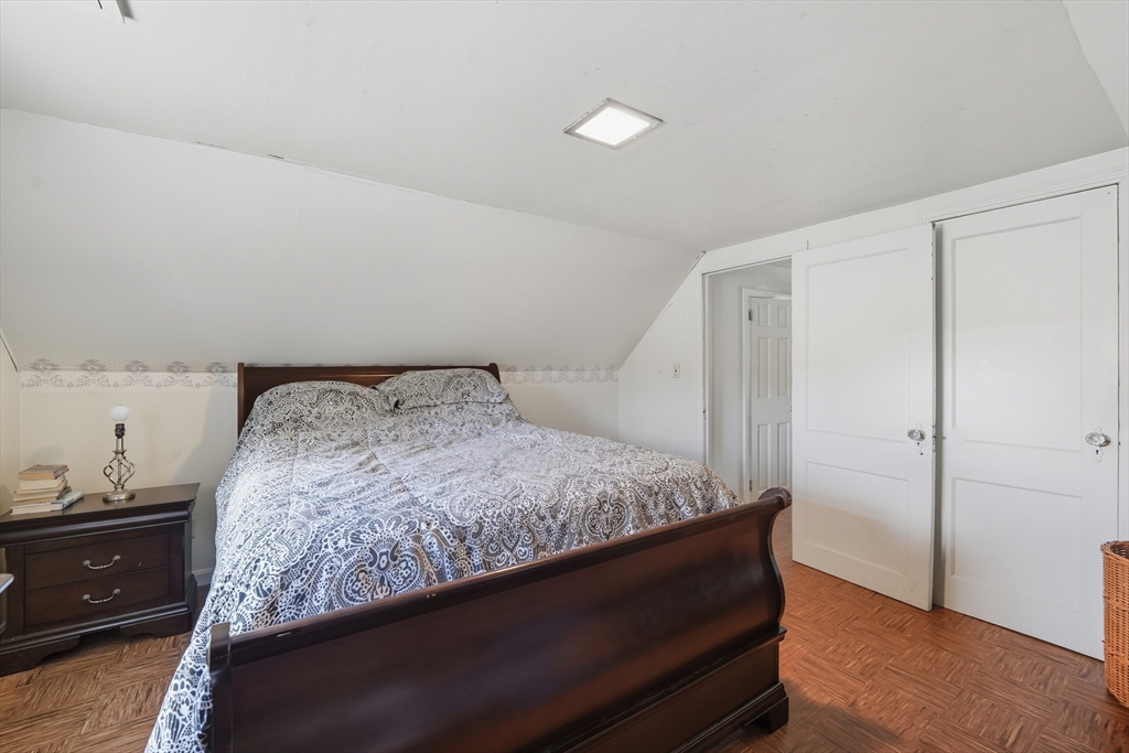 145 Amostown Road West Springfield, MA 01089 - Photo 21 of 26 a bedroom with a bed and wooden floor