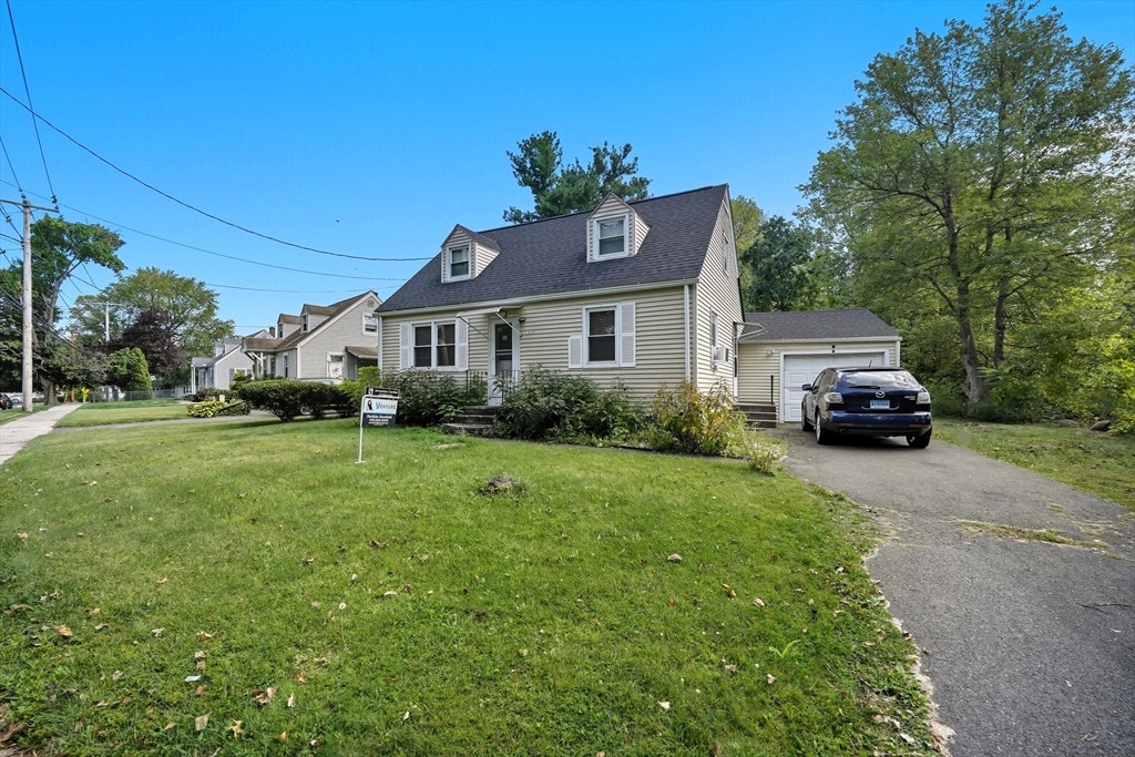 145 Amostown Road West Springfield, MA 01089 - Photo 3 of 26 a car parked in front of a house with a yard