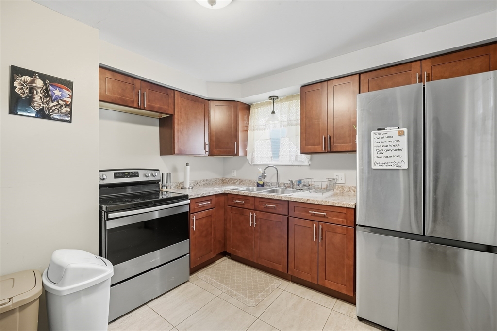 145 Amostown Road West Springfield, MA 01089 - Photo 4 of 26 a kitchen with stainless steel appliances granite countertop a refrigerator sink and stove