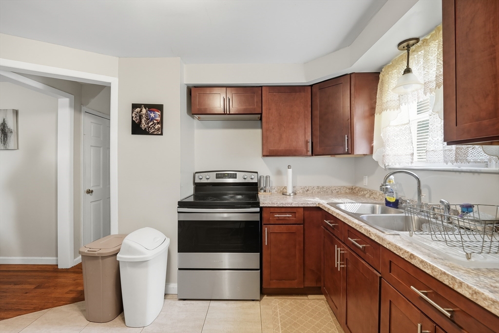 145 Amostown Road West Springfield, MA 01089 - Photo 5 of 26 a kitchen with a sink stove and cabinets