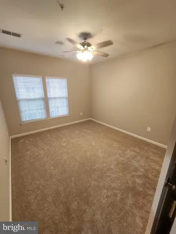 a spacious bathroom with a granite countertop sink a toilet and shower