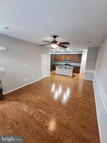 a kitchen with kitchen island granite countertop a sink a stove and refrigerator
