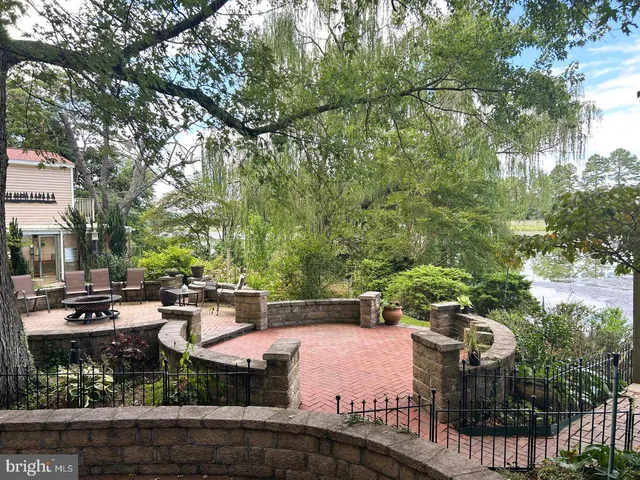 a front view of a house with a yard and lake view
