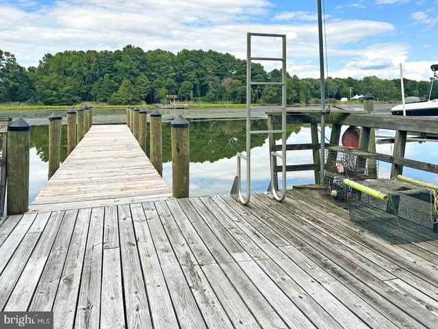 a view of a wooden deck with a lake view