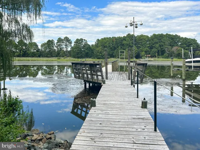 a view of a patio with chairs next to a yard