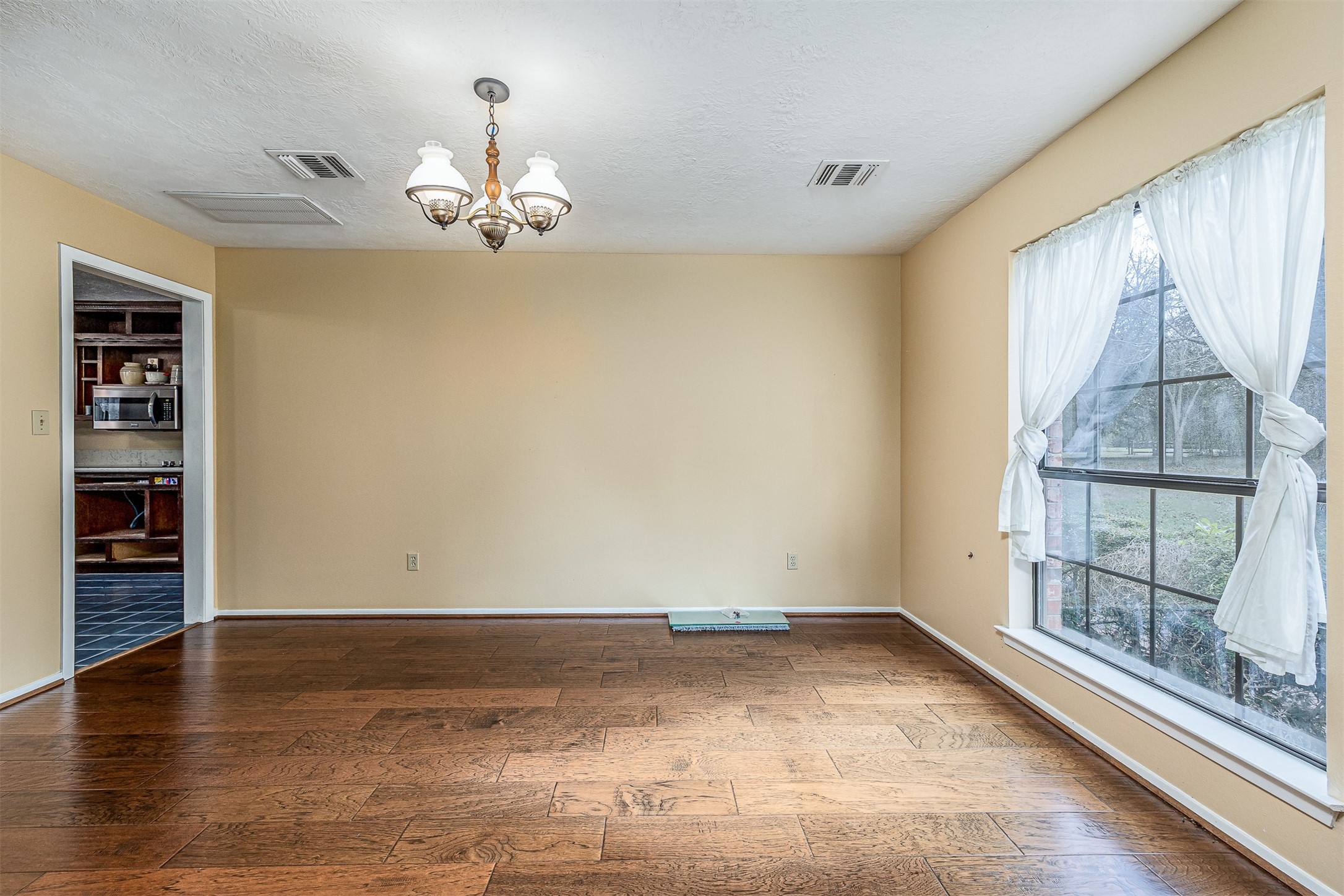 329 Burwell Road Highlands, TX 77562 - Photo 14 of 44 wooden floor in an empty room with a window