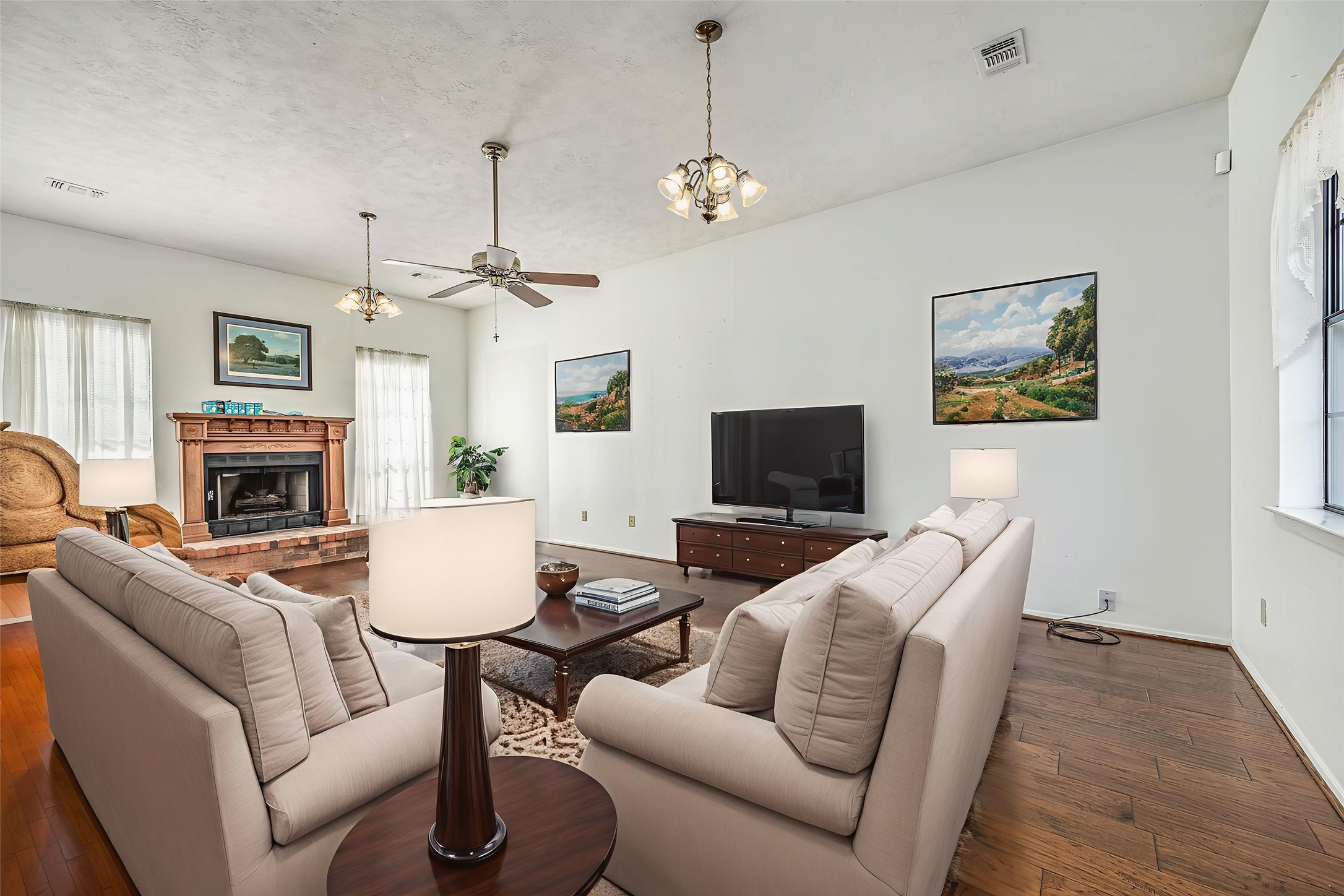 329 Burwell Road Highlands, TX 77562 - Photo 18 of 44 a living room with furniture a fireplace and a flat screen tv