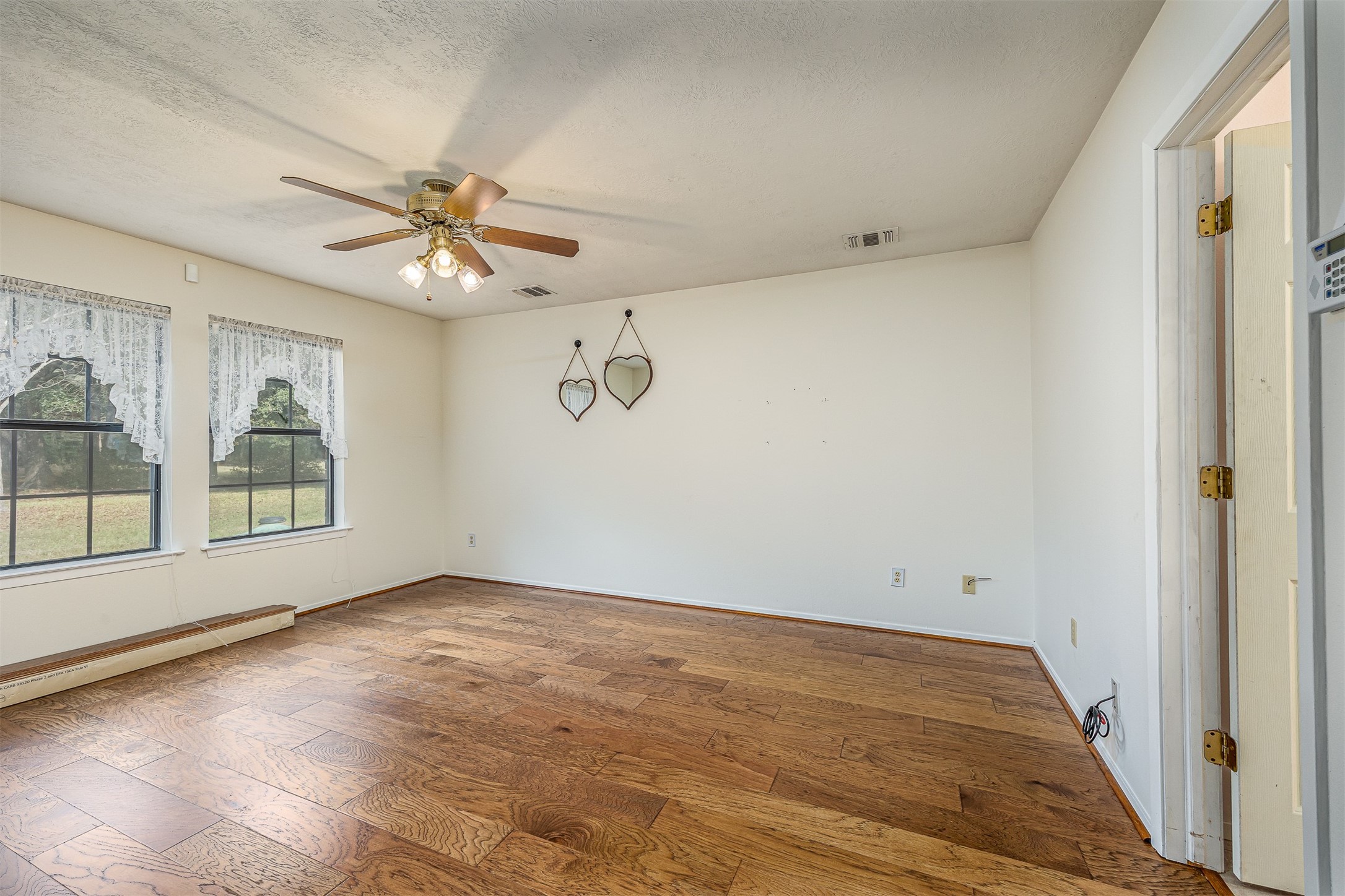 329 Burwell Road Highlands, TX 77562 - Photo 24 of 44 an empty room with windows and fan