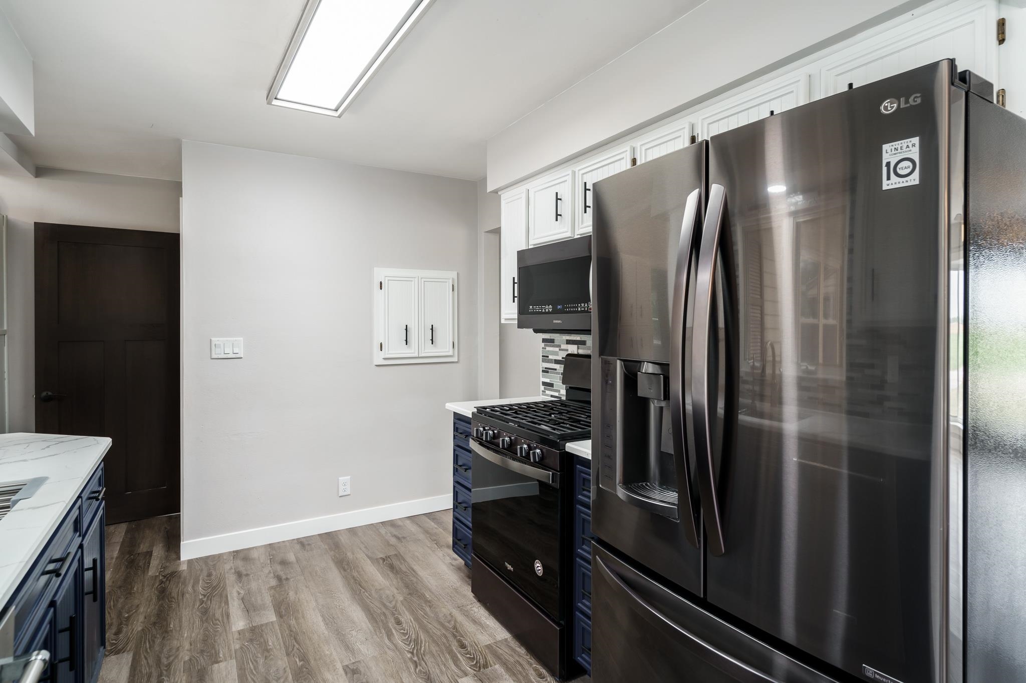 6780 Manchester Road South Beloit, IL 61080 - Photo 12 of 44 a kitchen with a refrigerator and a stove top oven